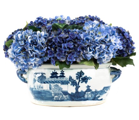 Beautiful blue hydrangea arrangement in elegant fishbowl